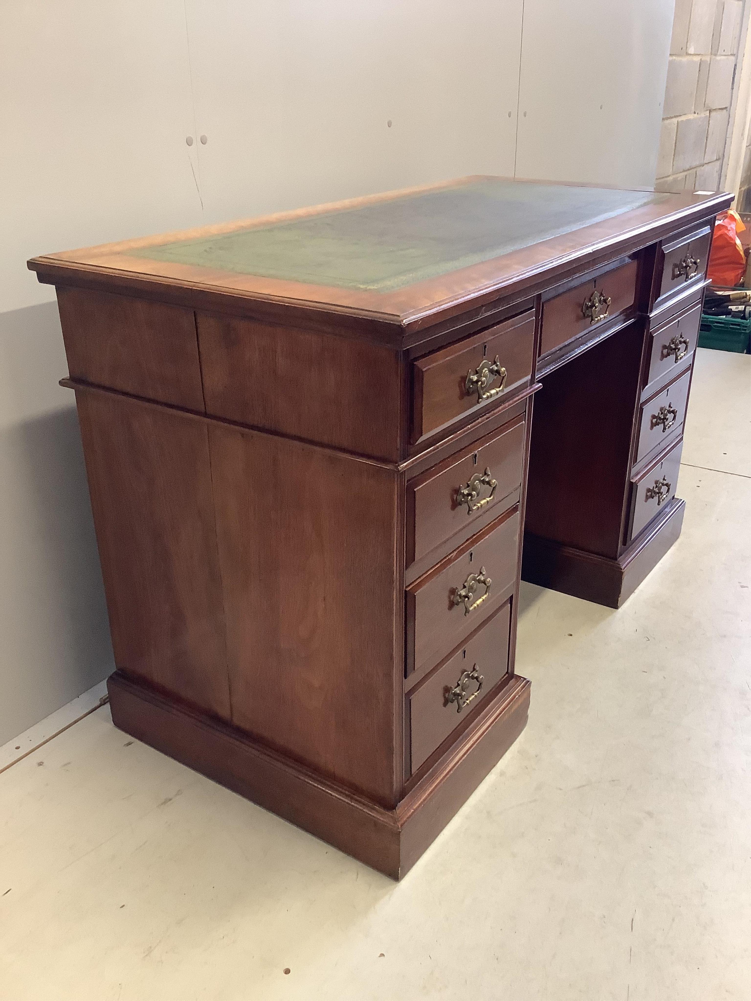 A late Victorian mahogany kneehole pedestal desk, fitted nine small drawers, width 121cm, depth 59cm, height 77cm. Condition - fair to good